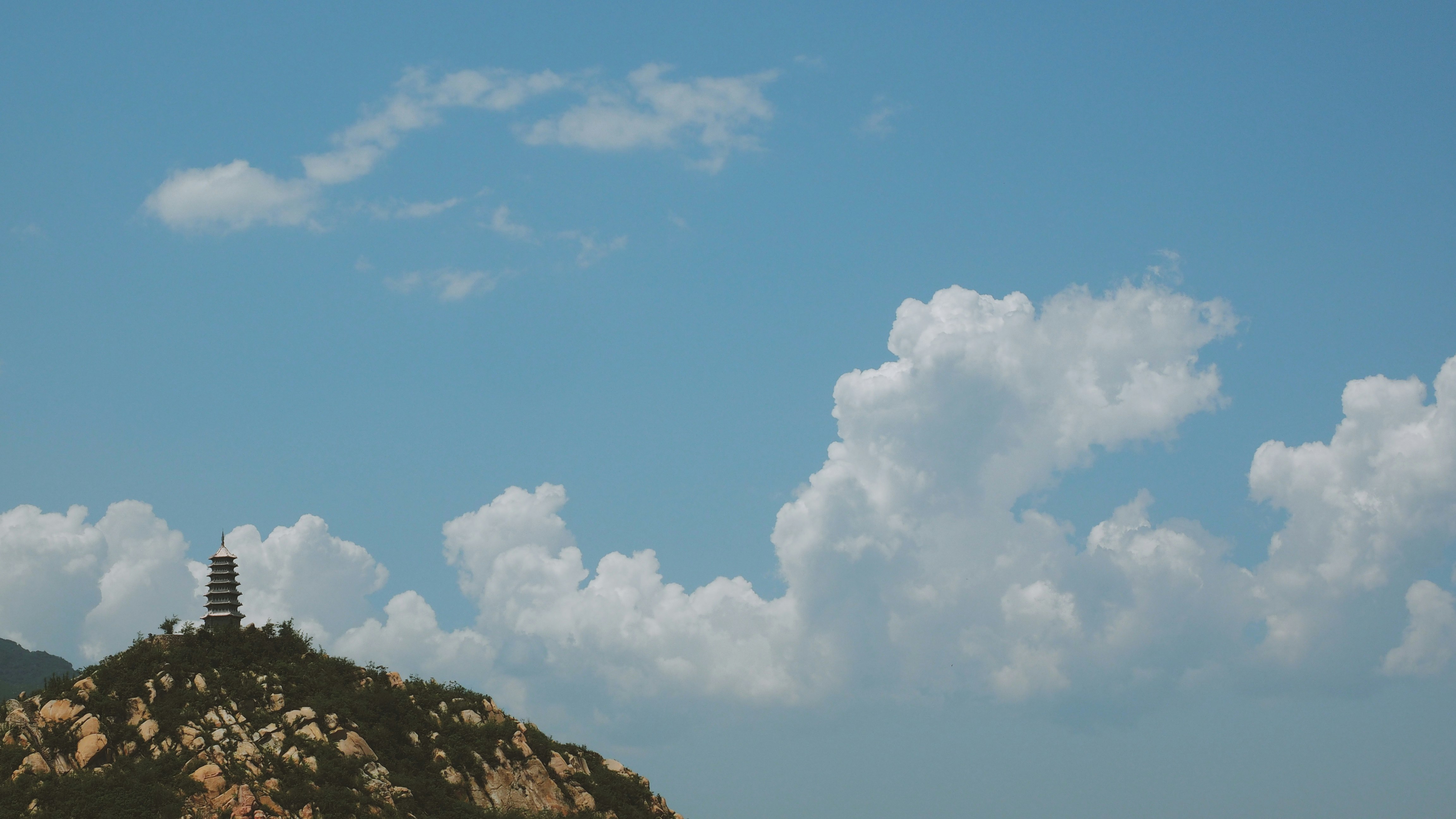 white clouds over black pagoda during daytime